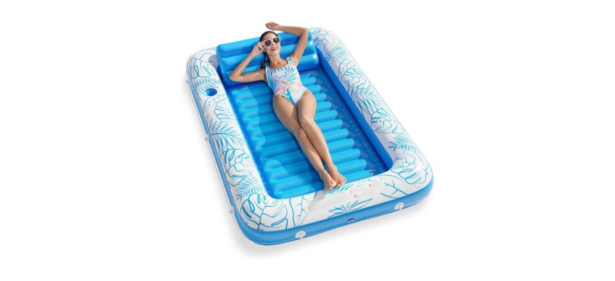 woman in swimsuit lying on a blue Jasonwell Inflatable Tanning Pool Lounger Float