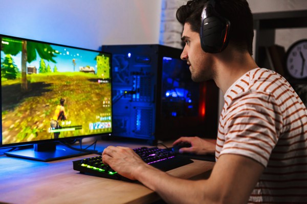 Person playing video games sitting at a desk